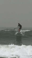 Paddleboarder navigates choppy waters off Tel Aviv coast