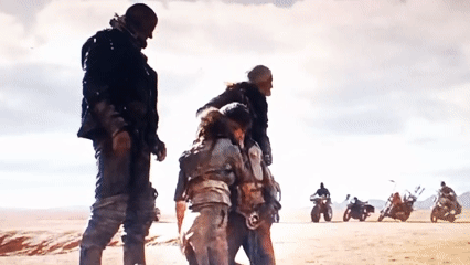 Desert crane vehicle operation involves four people lifting activity