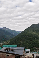 Panoramic mountain views captured in Vashisht, India under cloudy skies