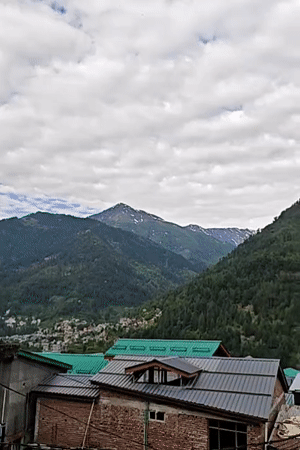 Panoramic mountain views captured in Vashisht, India under cloudy skies