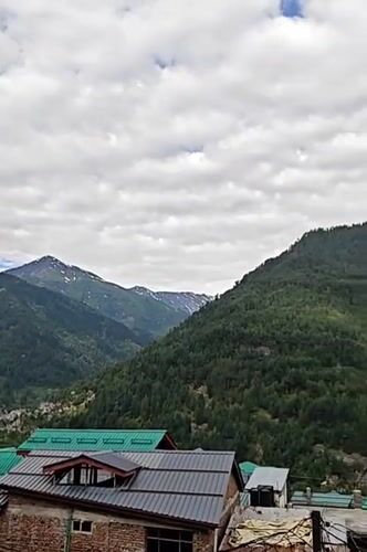 Panoramic mountain views captured in Vashisht, India under cloudy skies