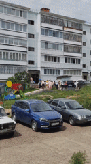 Group outside apartment block, then aboard transit in Noviy