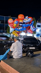 Evening street vendors and carnival rides active in Lhokseumawe