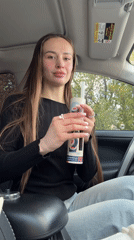 Woman displays Sushi Party container contents in Kyiv car