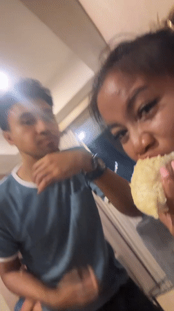 Two people share durian fruit indoors in Central Jakarta