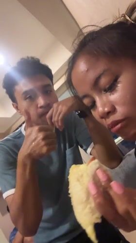 Two people share durian fruit indoors in Central Jakarta