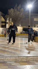 Young skateboarders practice tricks at Tacna plaza during late night