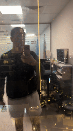 Office worker takes evening selfie against Dubai city lights