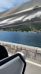 Tourists ride open-air transport along Montenegro coastal road
