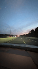 Highway driving near Düsseldorf under a fading dusk sky