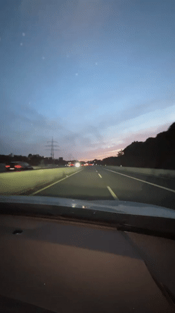 Highway driving near Düsseldorf under a fading dusk sky