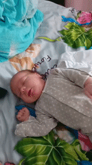 Baby sleeps peacefully in polka-dot romper in Andreyevo