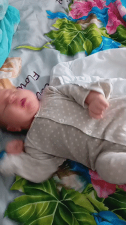 Baby sleeps peacefully in polka-dot romper in Andreyevo