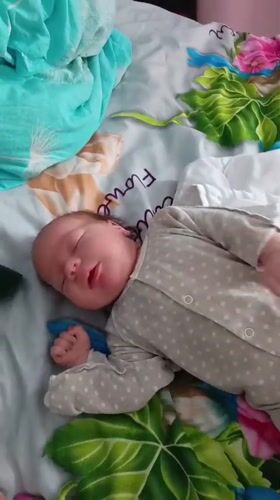 Baby sleeps peacefully in polka-dot romper in Andreyevo