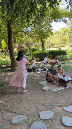 Diners interact with ducks at Indonesian outdoor cafe