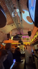 Evening at a Krasnoyarsk bar with disco ball and brick walls
