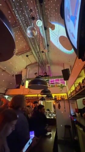 Evening at a Krasnoyarsk bar with disco ball and brick walls