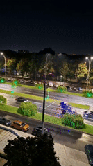 Ambulance and traffic on a wet Chișinău street at night