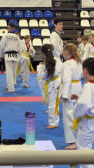 Children's taekwondo training session captured at indoor facility