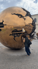 Visitor documents Vatican Museums artworks during afternoon tour