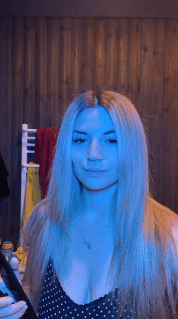 Woman styles hair while caring for toddler in Wisła bathroom
