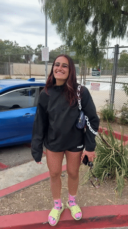 Woman deals with flat tire in LA parking lot