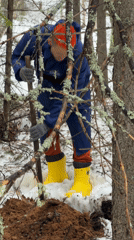 Person digging in snowy Russian forest near Chaikovsky