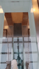 Person walks on glass floor in Verkhnyaya Pyshma building