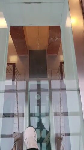 Person walks on glass floor in Verkhnyaya Pyshma building