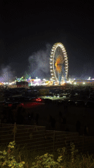 Illuminated Ferris wheel draws crowds to Munich fairground