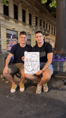 Street artist draws caricatures for customers in Belgrade evening