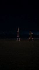 Nighttime beach activities captured along Đà Nẵng's illuminated coastline