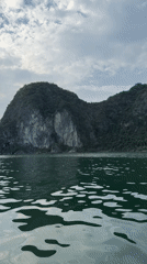 Boats navigate iconic limestone formations in Ha Long Bay