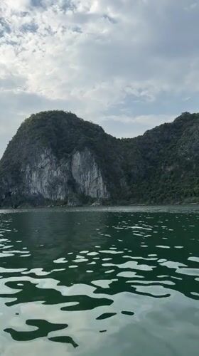 Boats navigate iconic limestone formations in Ha Long Bay
