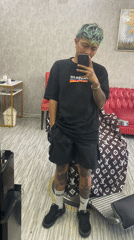 Tattooed man takes late-night selfie in upscale Kuta barbershop