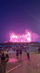 Fireworks over Saint-Denis paint the night pink and purple