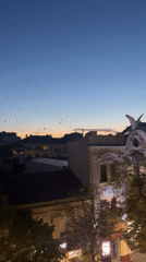 Evening dusk captured over Burgas cityscape with flying birds