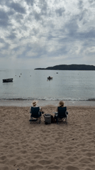 Beachgoers relax in chairs on Montenegro coast