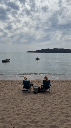 Beachgoers relax in chairs on Montenegro coast
