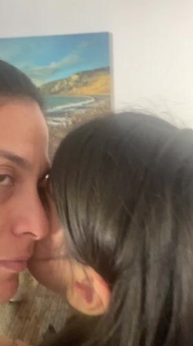 Mother and child share quiet moment in Cabo Frio home
