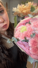 Woman with carnation bouquet spotted at Liepāja flower shop