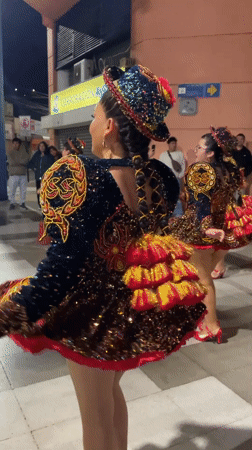 Nighttime street festival with costumed dancers and live performers