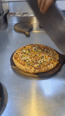 Pizza slicing and fry prep in a Lahore commercial kitchen
