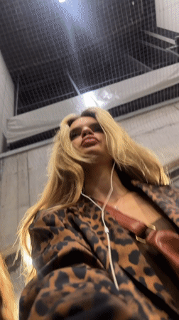 Leopard print jacket, white earbuds, inhaler — Berlin street stroll