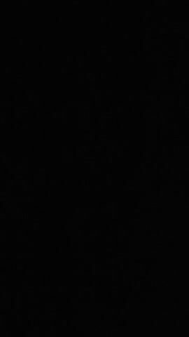 The video begins with a black screen, indicating a period of silence or no visual content. This is followed by a faint, muffled sound that could be interpreted as speech, though it is indistinct. The screen remains black throughout the duration of the clip.