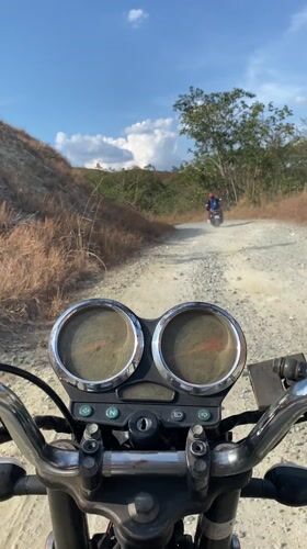 Motorcyclists ride rural dirt roads in Venezuela countryside