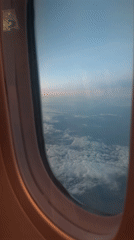 Flight passengers document aerial views and travel moments over Russia