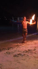 Fire dancer performs nighttime show at Choeng Mon beach Thailand