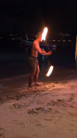 Fire dancer performs nighttime show at Choeng Mon beach Thailand