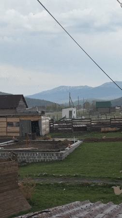 Light spring snowfall blankets rural Tyulyuk landscape